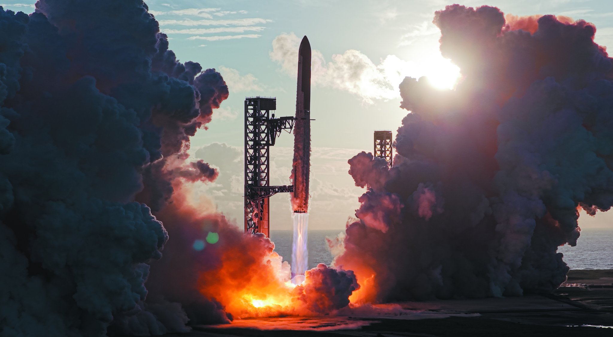 Starship decolando ao lado da torre, com o sol da manhã atrás das nuvens de exaustão